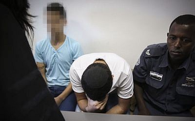 Police escort two Jewish minors, suspected of taking part in the murder of Muhammad Abu Khdeir, at the Jerusalem District Court, Jerusalem, June 3, 2015. (Hadas Parush/Flash90) Police escort two Jewish minors, suspected of taking part in the murder of Muhammad Abu Khdeir, at the Jerusalem District Court, Jerusalem, June 3, 2015. (Hadas Parush/Flash90)