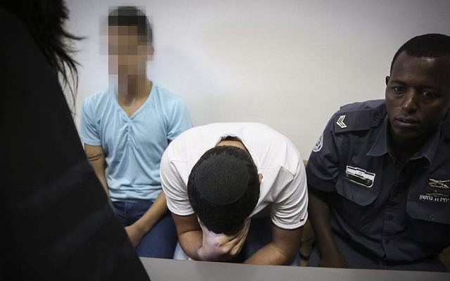 Police escort two Jewish minors, suspected of taking part in the murder of Muhammed Abu Khdeir, at the Jerusalem District Court, Jerusalem, June 3, 2015. (Hadas Parush/Flash90) Police escort two Jewish minors, suspected of taking part in the murder of Muhammed Abu Khdeir, at the Jerusalem District Court, Jerusalem, June 3, 2015. (Hadas Parush/Flash90)