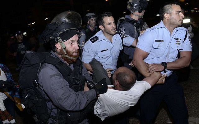 An Ethiopian Israeli is detained by police officers during a protest march in Rabin Square, Tel Aviv, June 22, 2015.