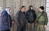 Israeli security forces speak with Palestinians residents of Hebron in the West Bank on December 13, 2015. (Gershon Elinson/Flash90)