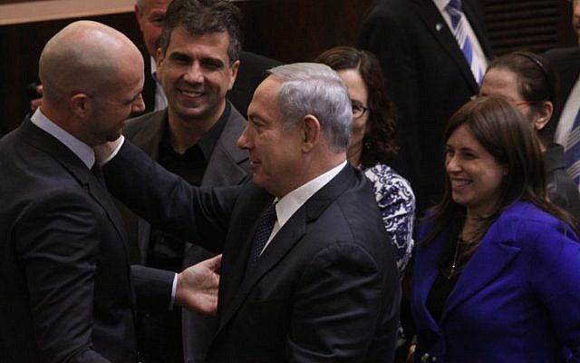 New Likud MK Amir Ohana is congratulated after his swearing-in during a plenum session in the Israeli parliament, on December 28, 2015. (Isaac HArari/FLASH90)