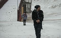 Israelis in the snow on Mount Hermon during a winter storm sweeping through the country, December 31, 2015. (Basel Awidat/Flash90)