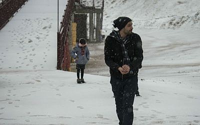 Israelis in the snow on Mount Hermon during a winter storm sweeping through the country, December 31, 2015. (Basel Awidat/Flash90)