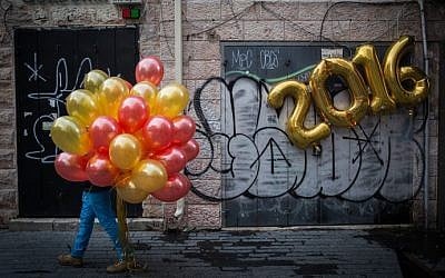 A man walks with balloons past a festive "2016" balloon display on New Year's Eve in central Jerusalem, December 31, 2015. (Hadas Parush/Flash90) A man walks with balloons past a festive "2016" balloon display on New Year's Eve in central Jerusalem, December 31, 2015. (Hadas Parush/Flash90)