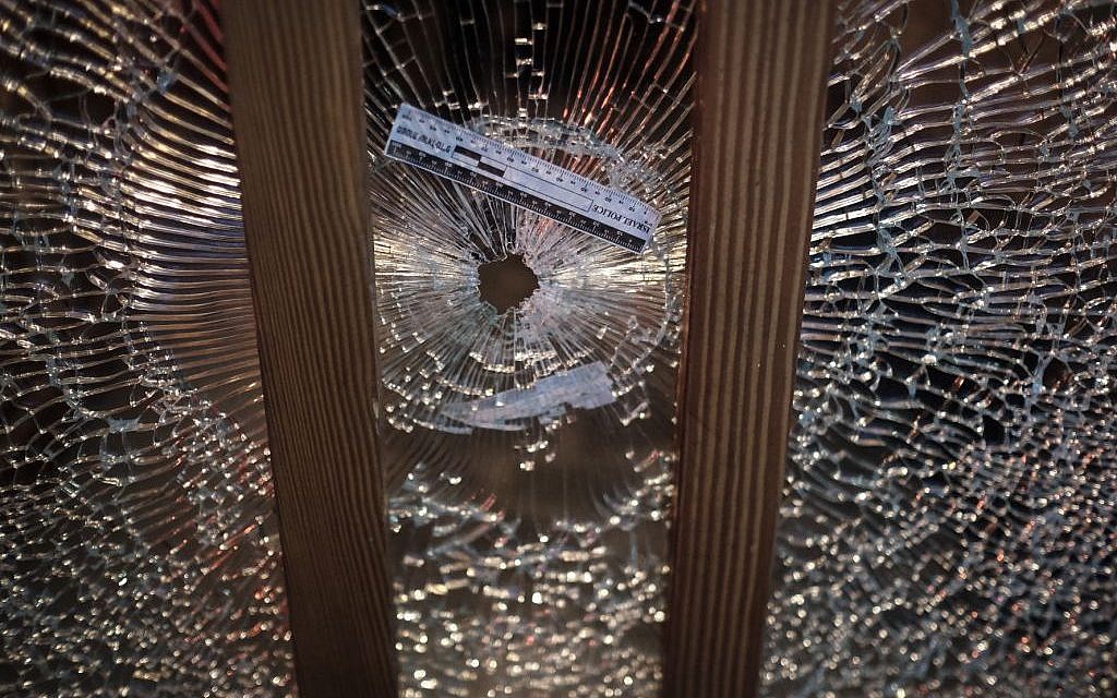A gun shot hole in a glass window at the scene of a shooting attack at the Simta bar in central Tel Aviv, on Friday, January 1, 2016. (Tomer Neuberg/Flash90)