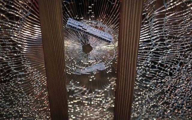 A gun shot hole in a glass window at the scene of a shooting attack at the Simta bar in central Tel Aviv, on Friday, January 1, 2016. (Tomer Neuberg/Flash90)