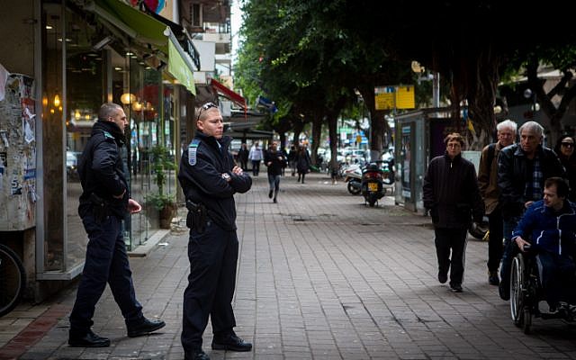 Israeli Police stand guard outside the scene of a shooting on Dizengoff Street in central Tel Aviv, on January 02, 2016, a day after two people were killed and several injured. (Miriam Alster/Flash90) Israeli Police stand guard outside the scene of a shooting on Dizengoff Street in central Tel Aviv, on January 02, 2016, a day after two people were killed and several injured. (Miriam Alster/Flash90)