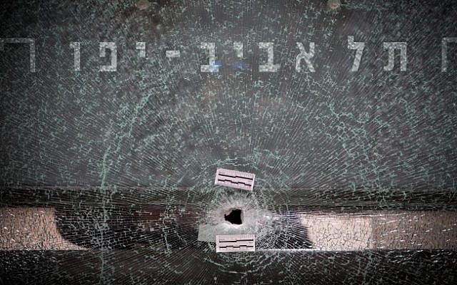 A gun shot hole in a glass bus stop shelter on January 2, 2016, at the scene of a shooting attack at a pub on Dizengoff Street in central Tel Aviv. (Miriam Alster/Flash90)
