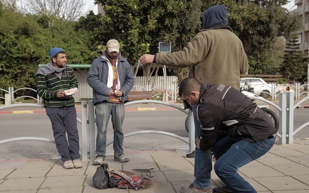 Israeli security forces frisk Arab Israelis near the Central Bus Station in Herzliya, as forces search for a suspect after an alert of an impending terror attack, January 5, 2016. (Tomer Neuberg/Flash90)