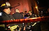 Firefighters work to extinguish a blaze at the Jerusalem offices of left-wing NGO B'Tselem, on January 10, 2016. (Yonatan Sindel/Flash90)