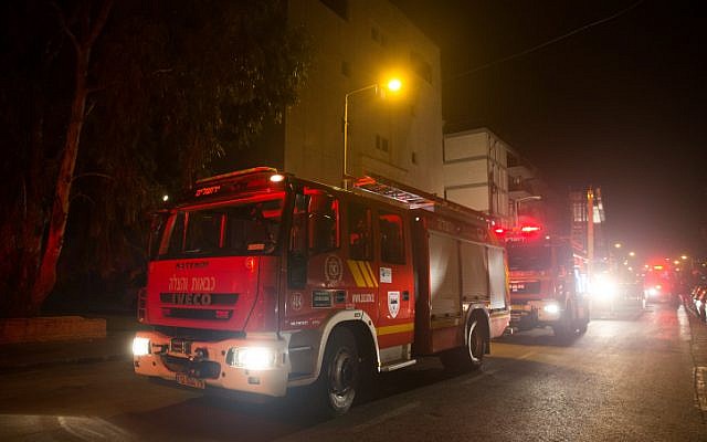 Firefighting teams work to put out a fire at the building where the offices of the human rights NGO B'Tselem are located, in Jerusalem on January 10, 2016. Police were investigating whether it was arson. (Yonatan Sindel/Flash90)