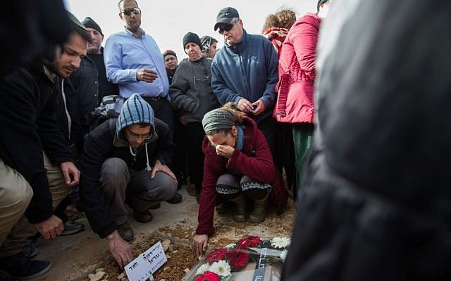 People mourn over the fresh grave of Dafna Meir, during her funeral in Jeursalem on January 18, 2016. (Yonatan Sindel/Flash90) People mourn over the fresh grave of Dafna Meir, during her funeral in Jeursalem on January 18, 2016. (Yonatan Sindel/Flash90)