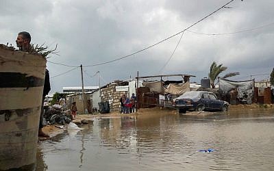 Palestinians stand near a road flooded with rainwater following heavy rains, in Khan Younis in the southern Gaza Strip on January 24, 2016. (Abed Rahim Khatib/Flash90) Palestinians stand near a road flooded with rainwater following heavy rains, in Khan Younis in the southern Gaza Strip on January 24, 2016. (Abed Rahim Khatib/Flash90)