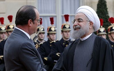 French President Francois Hollande greets Iranian President Hassan Rouhani before a meeting at the Elysee Palace, in Paris, January 28, 2016. During Rouhani's visit, Total and the National Iranian Oil Company signed two major energy deals (AP Photo/Christophe Ena)