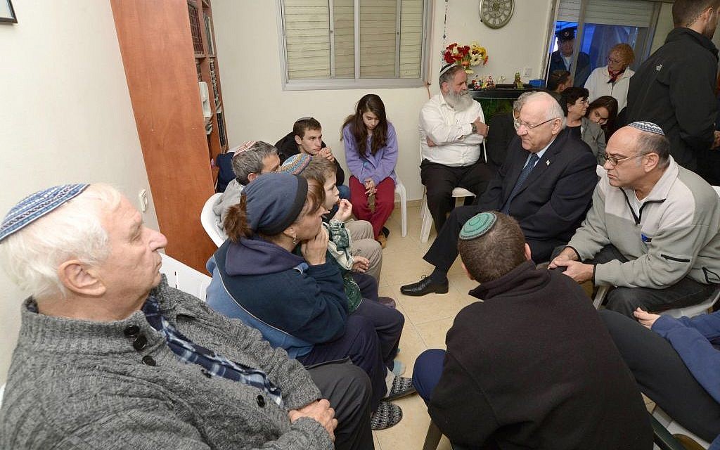President Reuven Rivlin visits the Krigman home to pay his condolences to the family after their 23-year-old daughter Shlomit is stabbed to death in a terror attack (Mark Neyman / GPO)