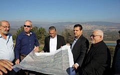 Housing Minister Yoav Gallant (second from left) and MK Ayman Odeh (second from right) stop at Eilabun, a village 15 kilometers (9 miles) south-west of Safed, during a tour of Arab villages in the Galilee, January 12, 2016. (Courtesy)