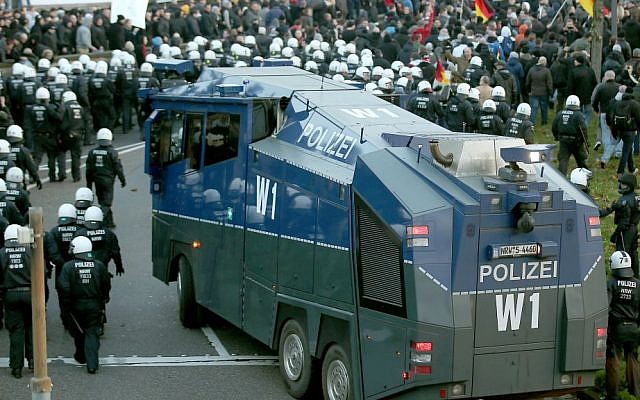 Police drive back right-wing demonstrators with a water cannon in Cologne, Germany, Saturday, Jan. 9, 2016. (Oliver Berg/dpa via AP) Police drive back right-wing demonstrators with a water cannon in Cologne, Germany, Saturday, Jan. 9, 2016. (Oliver Berg/dpa via AP)