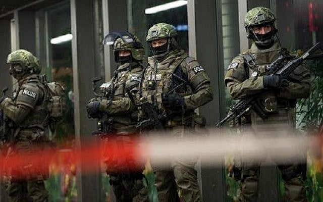 German special police stand in front of the main train station in Munich, southern Germany, on New Year's Eve, December 31, 2015. (Sven Hoppe/dpa via AP) German special police stand in front of the main train station in Munich, southern Germany, on New Year's Eve, December 31, 2015. (Sven Hoppe/dpa via AP)