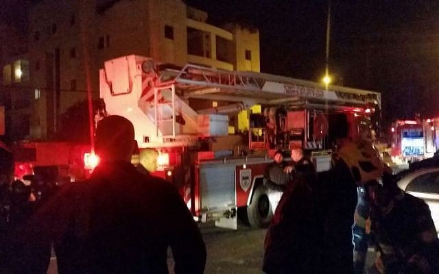 Firefighters at the scene of a blaze at the offices of left-wing NGO B'Tselem in Jerusalem on January 10, 2016. (Hagai El-Ad, B'Tselem)