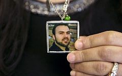 Naghmeh Abedini holds a necklace with a photograph of her husband, Saeed Abedini, on Capitol Hill in Washington, June 2, 2015 (AP Photo/Jacquelyn Martin, File)