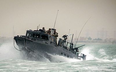 In this Oct. 30, 2015, photo provided by the US Navy, Riverine Command Boat (RCB) 805, along with its crew members, is shown transiting through rough seas during patrol operations in the Persian Gulf. (Torrey W. Lee/US Navy via AP)