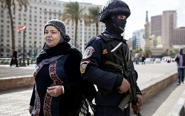 Illustrative: A woman walks past an Egyptian policeman, a day ahead of the fifth anniversary of the Jan. 25, 2011 uprising in Tahrir Square, Cairo, Egypt on Jan. 24, 2016. (AP Photo/Roger Anis) Illustrative: A woman walks past an Egyptian policeman, a day ahead of the fifth anniversary of the Jan. 25, 2011 uprising in Tahrir Square, Cairo, Egypt on Jan. 24, 2016. (AP Photo/Roger Anis)