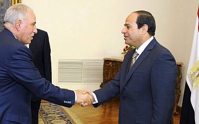 In this Wednesday, May 20, 2015 file picture provided by the office of the Egyptian Presidency, Egyptian President Abdel-Fattah el-Sissi, right, shakes hands with newly-appointed Justice Minister Ahmed el-Zind during a swearing-in ceremony in Cairo, Egypt. (Egyptian Presidency via AP)