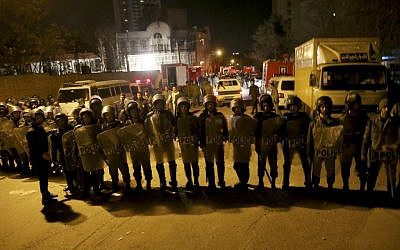 Iranian security stand guard to protect Saudi Arabia's embassy in Tehran, Iran, while a group of demonstrators gathered to protest execution of a Shiite cleric in Saudi Arabia, Sunday, Jan. 3, 2016. (AP Photo/Ebrahim Noroozi)