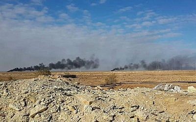 Smoke rises following a US-led coalition airstrike on Islamic State group positions, outside Haditha, Iraq, on January 5, 2016. (AP)