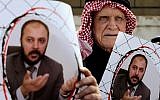 Supporters of Zaki Bani Irsheid, a top leader of the Muslim Brotherhood opposition group, hold photos of him, outside the state security court in Amman, Jordan, February 15, 2015. (AP Photo/Raad Adayleh)