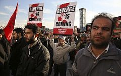 Iranian demonstrators hold anti-Saudi placards in a rally to protest the execution by Saudi Arabia last week of Sheikh Nimr al-Nimr, a prominent opposition Saudi Shiite cleric, in Tehran, Iran, January 4, 2016. (AP/Vahid Salemi)