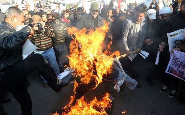 In this Monday, Jan. 4, 2016 file photo, followers of Shiite cleric Muqtada al-Sadr burn an effigy of King Salman of Saudi Arabia as they hold posters of Sheikh Nimr al-Nimr during a demonstration in Baghdad, Iraq. (AP Photo/Khalid Mohammed, File) In this Monday, Jan. 4, 2016 file photo, followers of Shiite cleric Muqtada al-Sadr burn an effigy of King Salman of Saudi Arabia as they hold posters of Sheikh Nimr al-Nimr during a demonstration in Baghdad, Iraq. (AP Photo/Khalid Mohammed, File)