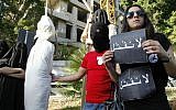 Illustrative: In this photo from April 1, 2010, activists from a civil organization reenact an execution scene in front of the Saudi Arabia Embassy in Beirut, Lebanon, as they protest a possible beheading of a Lebanese man accused of witchcraft in Saudi Arabia. (AP/Bilal Hussein, File)