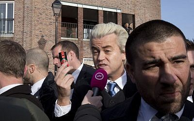Firebrand Dutch lawmaker Geert Wilders talks to a TV reporters as he hands out "self-defense sprays" to women fearful of being attacked by migrants, in the center of Spijkenisse, near Rotterdam, Netherlands, Saturday, Jan. 23, 2016. (AP Photo/Peter Dejong) 