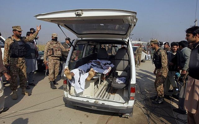 Pakistani troops clear way for an ambulance transporting a lifeless body of a victim from Bacha Khan University in Charsadda town, some 35 kilometers (21 miles) outside the city of Peshawar, January 20, 2016. (AP Photo/Mohammad Sajjad)