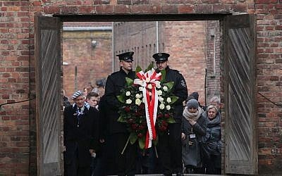 Soldiers hold a wreath at the former Auschwitz Nazi death camp in Oswiecim, Poland on Jan. 27, 2016, at the 71st anniversary of the death camp's liberation by the Soviet Red Army in 1945. (AP Photo/Czarek Sokolowski) 