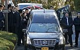 Family members gather at the rear of a hearse carrying the casket during the funeral for Dr. Robin Goldman, a 58-year-old pediatrician found slain inside her multimillion-dollar Scarsdale, NY, home on January 21, 2016. (AP/Kathy Willens)