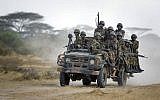 In this Monday, Feb. 20, 2012 file photo, Kenyan army soldiers ride on a vehicle at their base in Tabda, inside Somalia. (AP Photo/Ben Curtis, File)