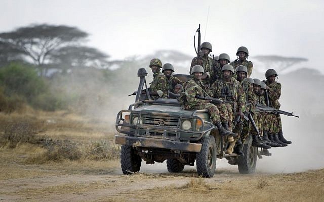 In this Monday, Feb. 20, 2012 file photo, Kenyan army soldiers ride on a vehicle at their base in Tabda, inside Somalia. (AP Photo/Ben Curtis, File)