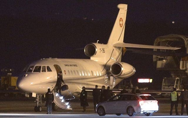 An unidentified man leaves a Dassault Falcon jet of Swiss army at the airport in Geneva, Switzerland, Sunday, January 17, 2016. (AP/Laurent Cipriani)