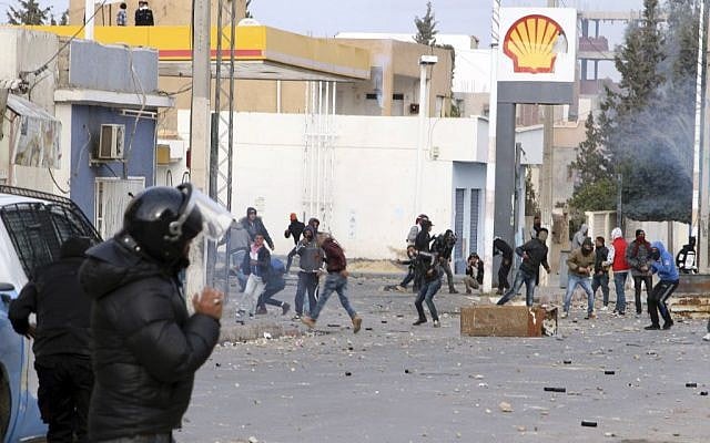 Protesters throw items to police forces in the city of Ennour, near Kasserine, Tunisia, Wednesday, Jan. 20, 2016. (AP Photo/Moncef Tajouri) Protesters throw items to police forces in the city of Ennour, near Kasserine, Tunisia, Wednesday, Jan. 20, 2016. (AP Photo/Moncef Tajouri)