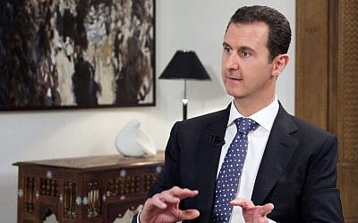 In this photo released by the Syrian official news agency SANA, shows Syrian President Bashar Assad, speaking during an interview with the Spanish news agency EFE, in Damascus, Syria, Friday, Dec. 11, 2015. (SANA via AP) 