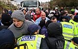 Right-wing protestors push through police lines at an anti-immigration demonstration in Dover, southeastern England, Saturday Jan. 30, 2016. (Gareth Fuller/PA via AP)