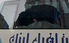 The broken window of a bus used by Arab Israeli tourists following an attack in Cairo on January 7, 2016 (screen capture: Channel 2)