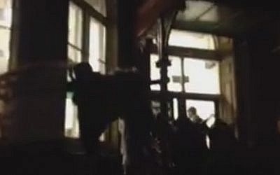 Pro-Palestinian activists bang on the windows of an Israel Society event featuring former Shin Bet chief Ami Ayalon at King's College, London on January 19, 2016 (screen capture: Facebook)