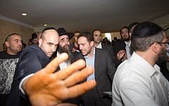 Rabbi Yoshiyahu Pinto, in hat, leaves the Supreme Court in Jerusalem after appealing his sentence, November 16, 2015. (Yonatan Sindel/Flash90)