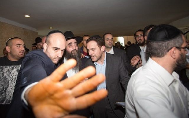 Rabbi Yoshiyahu Pinto, in hat, leaves the Supreme Court in Jerusalem after appealing his sentence, November 16, 2015. (Yonatan Sindel/Flash90) Rabbi Yoshiyahu Pinto, in hat, leaves the Supreme Court in Jerusalem after appealing his sentence, November 16, 2015. (Yonatan Sindel/Flash90)