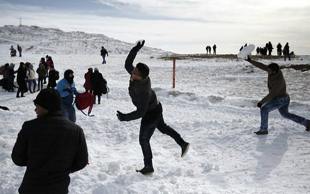 Arab boys throw snowballs at their friends at the Mount Hermon ski resort on the Golan Heights, on January 21, 2016. (Thomas Coex/AFP)
