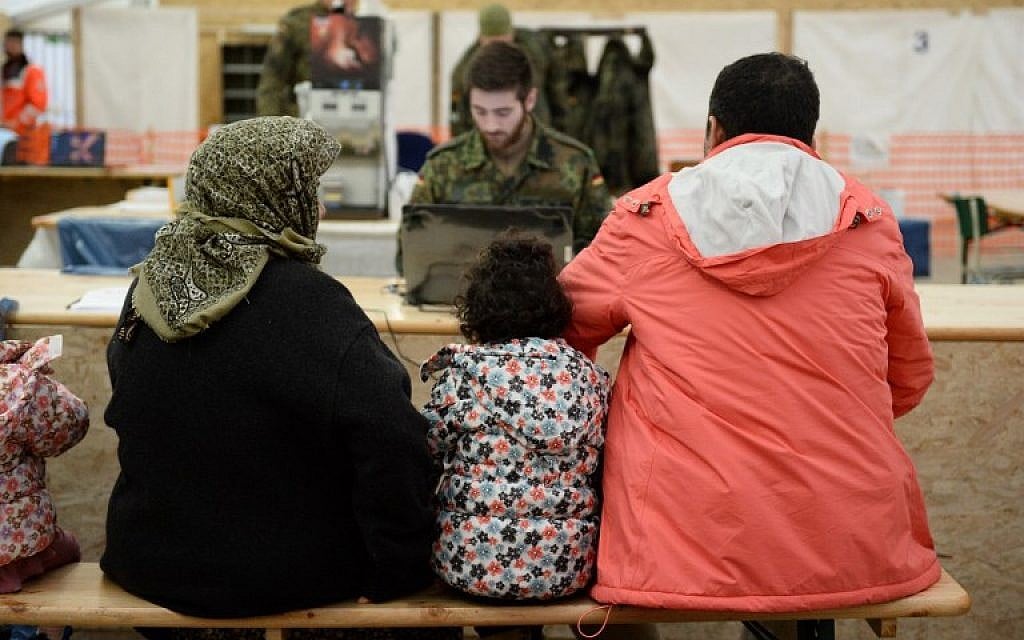 Refugees from Syria wait to register at the German army's air base in Erding, southern Germany, on January 31, 2016. (AFP/dpa/Andreas GEBERT) Refugees from Syria wait to register at the German army's air base in Erding, southern Germany, on January 31, 2016. (AFP/dpa/Andreas GEBERT)
