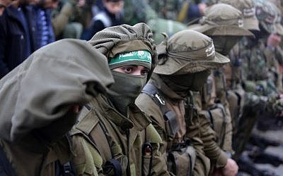 Palestinian members of the Izz ad-Din al-Qassam Brigades, the armed wing of the Hamas movement during the funeral of group member Ahmed al-Zahar in the village of Al-Moghraga near the Nuseirat refugee camp in the central Gaza Strip, February 3, 2016. (AFP/Mahmud Hams)